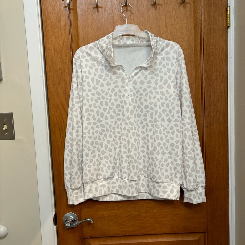 Pull over with zip up neckline.